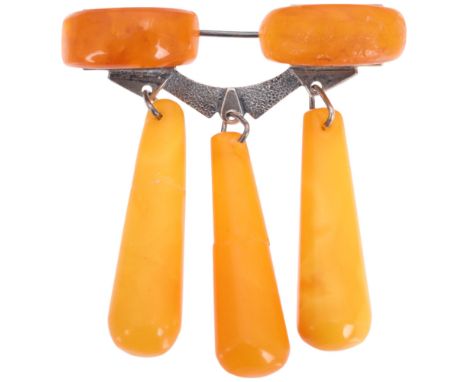 An Arts and Crafts style Russian silver Baltic amber drop brooch, height 50mm, 8.6g . Condition Report: 2 drops have been bro