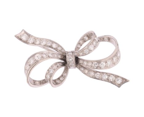 A 9ct white gold diamond ribbon bow brooch, indistinct maker, London 2004, in the Art Deco style, grain set with graduated mo