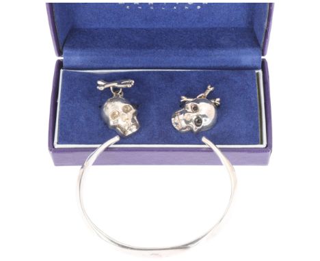 A pair of sterling silver skull and crossbones cufflinks, and a silver cuff bangle (2) . Condition Report:No damage or repair