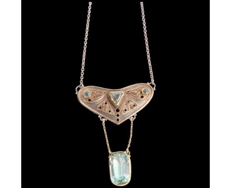 An Arts and Crafts silver-gilt aquamarine pendant necklace, openwork form suspending elongated oval cushion-cut aquamarine, o