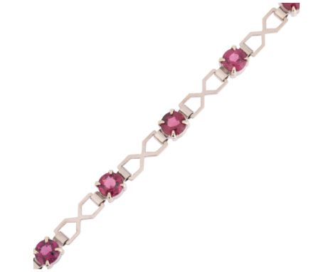 An Art Deco 9ct white gold almandine garnet tennis line bracelet, geometric openwork form, claw set with round-cut garnets, b