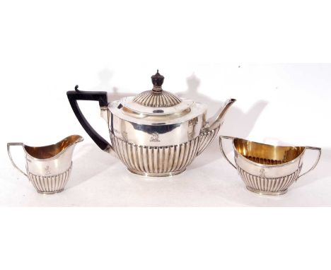 Late Victorian and later three piece tea set of half-fluted oval form, comprising tea pot with ebonised handle and finial, tw