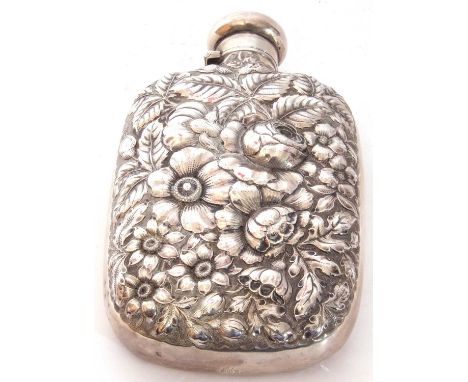 Antique spirit flask of typical form, one side heavily embossed with flowers and leaves etc, the verso engraved with monogram