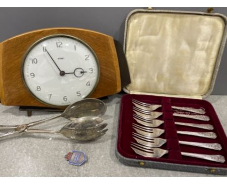 Box of cake forks, sterling silver nurses badge, salad servers and 1950/60s clock