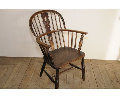 Elm stick back Windsor armchair with pierced central splat and H shaped under stretcher and turned supports 