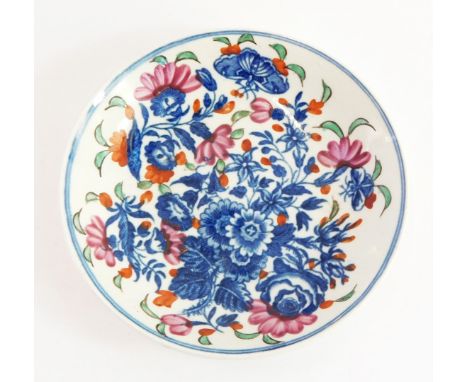 A Worcester First Period blue and white porcelain saucer, decorated in the Three Flowers pattern, later clobbered, blue hatch