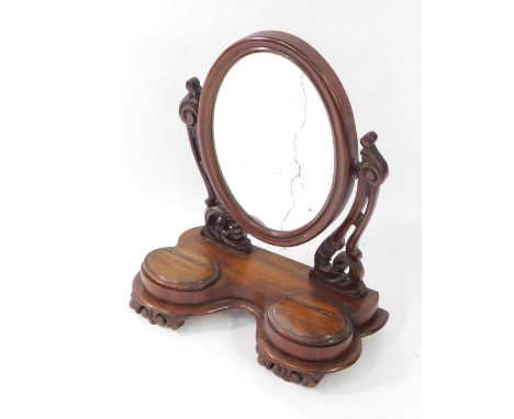 A Victorian mahogany dressing table mirror, with oval mirror plate, on two scrolled supports, with two out stepped trinket co