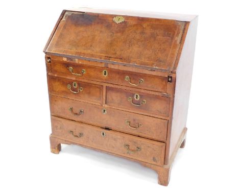 A George I walnut bureau, the fall opening to reveal a fitted interior, plate above arrangement of one long two short and two