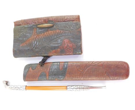 A Japanese bamboo and silver mounted opium pipe, in a black and red leather sheath, with matching pouch, bears label to shaft
