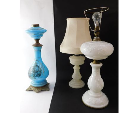 A Victorian pressed milk glass oil lamp, converted to electricity, moulded with vines, 59cm high, another milk glass oil lamp