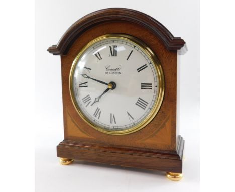 A Comitti of London Edwardian style mantel clock, circular white dial bearing Roman numerals, quartz movement, the case of do