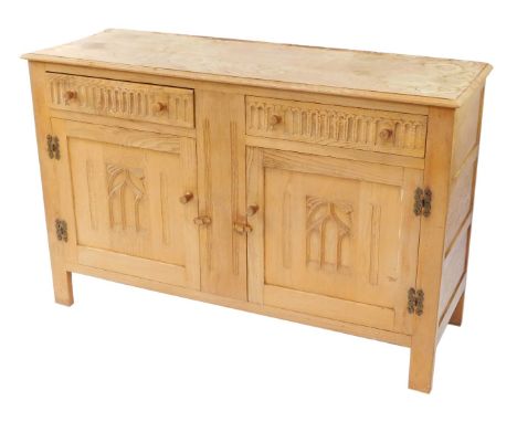 A Webber Furniture light oak sideboard, with two single drawers, above two cupboard doors, each with Gothic style arch, on st