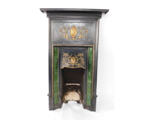 A Victorian fireplace surround, with cast shelf top and surround painted in black, with over painted Neo Classical style deta