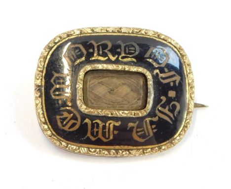 A Victorian 'In Memory Of' hair locket mourning brooch, black enamel and yellow metal.