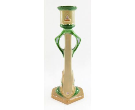 An Art Nouveau pottery candlestick, possibly Eichwald, with a green and brown mottled design, with shaped handles on a hexago