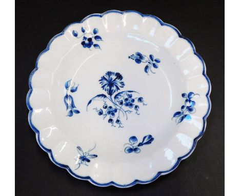 A Worcester First period blue and white porcelain plate, circa 1775-83, of fluted form, decorated in the Gilliflower pattern,
