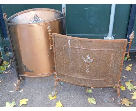 Two firescreens, comprising a copper curb firescreen in Art Deco style, and another with central shield emblem. 