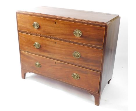 A George III mahogany chest of three long drawers,  each with stringing and brass oval backplate handles, on bracket feet, 93