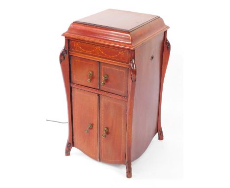 An Edwardian mahogany and inlaid gramophone cabinet, with domed top, enclosing a Garrod record player, with marquetry panelli