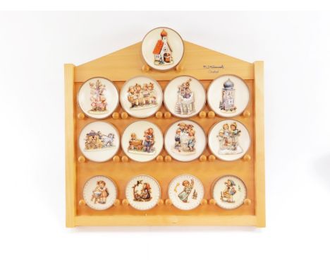 A group of Goebel Hummel collector's plates, on collector plate stand, to include Nos 1078., 1402., 1406., 1295., 1414., 1286