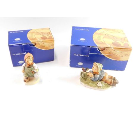 Two Goebel Hummel figures, comprising Grandma's Girl, and figure group of boy seated with a bird, boxed. 