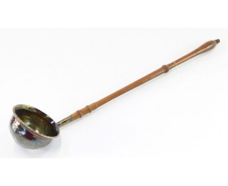 A Georgian toddy ladle, the white metal bowl engraved with initials, set to the base with a Queen Anne shilling, unmarked, on