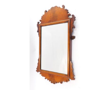 An Edwardian walnut fret framed wall mirror, with a arched and fret top, with outer scroll detailing, on rectangular mirror p