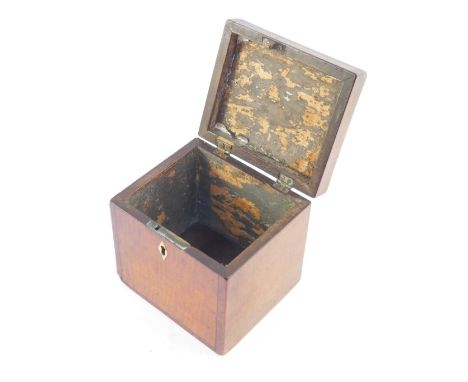 A George III satinwood tea caddy, with rosewood cross banding, oval paterae inlay to the lid, the keyhole with bone escutcheo