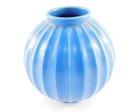 A Poole Pottery blue vase, with vertical ribbed fluting, printed mark, 12cm high.