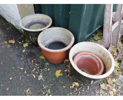A group of garden planters, comprising a pair of green glazed bamboo finish planters, 32cm high, terracotta planter and three