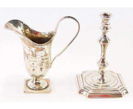 Two items of silver, comprising a Victorian loaded silver taper candlestick, London 1894, together with a silver helmet shape