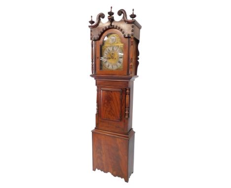 An early 19thC flame mahogany cased long case clock, the brass break arch dial with silver chapter ring bearing Roman numeral
