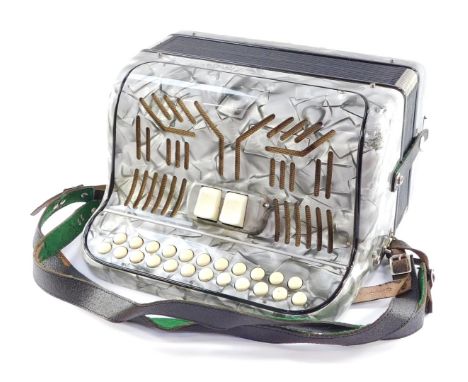 A Paolo Soprani piano accordion, in silvered overall detailing with ivory coloured buttons, cased, 31cm wide, 34cm deep.