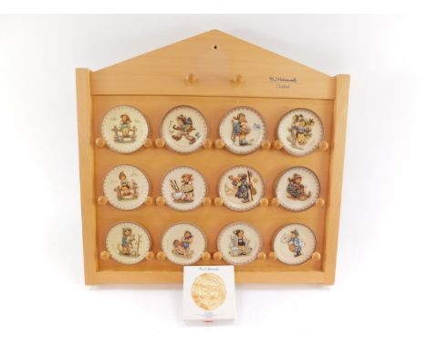 A group of Goebel by Hummel collector's plates, on modern wooden stand, to include Nos 1165., 1078., 1413., 1291., 1407., 128