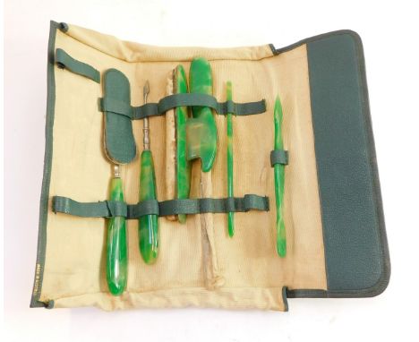 A jade effect finish manicure set, to include buffer, and other pieces, each on a green mottled ground in a blue leather trav