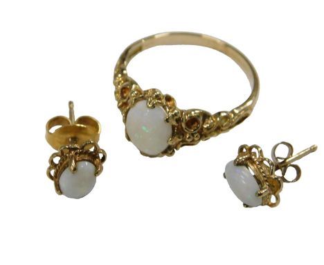 A 9ct gold and opal ring, size M½, together with a pair of matching single stud earrings, 3.5g.