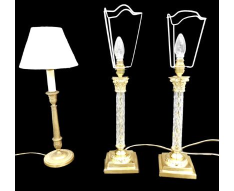 A pair of cut glass and gilt brass Corinthian column table lamps, 48cm high to top of bulb, and a further lamp.