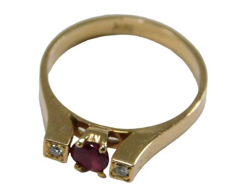 A 20thC ruby and diamond three stone dress ring, set with oval cut ruby, approx 4.5mm x 4mm x 3mm, 0.45ct, claw set, flanked 