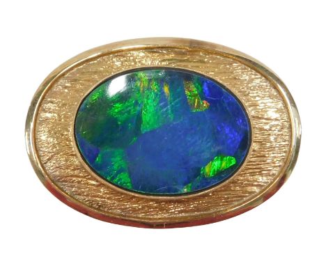 A 20thC opal doublet pendant, the oval doublet 21mm x 14mm, in an abstract bark effect rub over oval frame, yellow metal stam