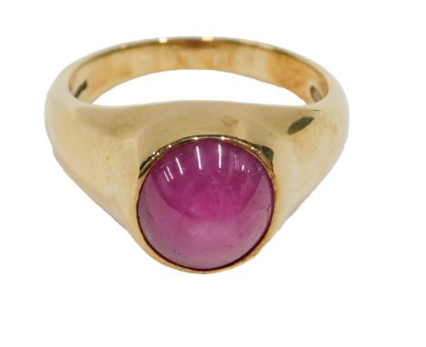 An 18ct gold star ruby 20thC dress ring, the single cabochon cut oval stone, 10mm x 8.5mm x .2mm, approx 6.59ct, in a rub ove