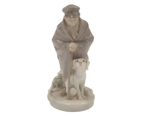 A Royal Copenhagen porcelain figure of a young boy with walking stick and dog, printed marks and handwritten numbers 782 and 