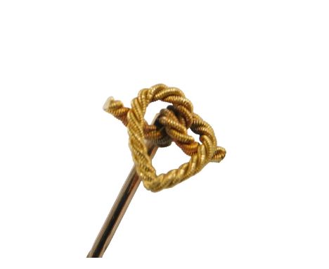 A yellow metal stick pin, the top modelled as a heart in stylised knotted rope, stamped 15, 1.3g, in fitted case.