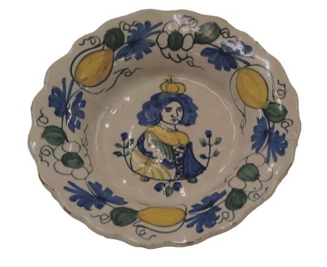 A 17thC Delft plate, decorated centrally with a portrait of Queen Mary of Holland, within floral borders picked out in blue, 