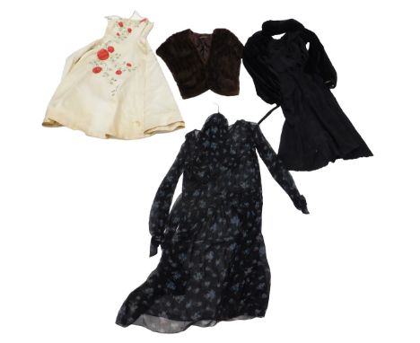 A group of vintage clothing, comprising a 1920s black mourning dress, together with a black velvet jacket, a 1950s pale yello