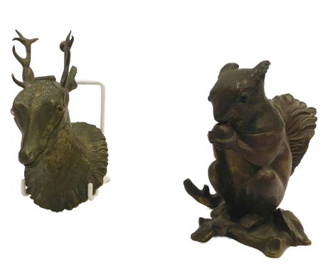 A novelty brass inkwell, modelled in the form of a squirrel holding an acorn, 12cm high, and another similar in the form of a