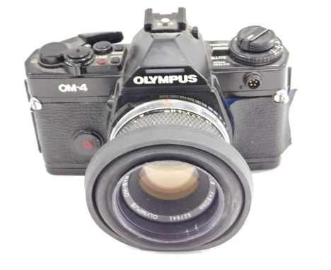 An Olympus OM-4 camera, with lens.