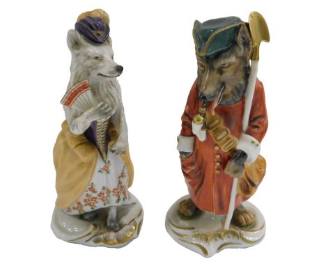 A pair of German porcelain figures, modelled in the form of a wolf wearing a coat, carrying a shovel whilst smoking a pipe, 1