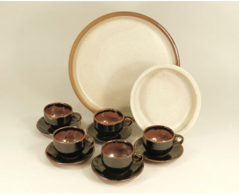 WINCHCOMBE Five coffee cups &amp; saucers, an oval bowl &amp; a platter. All with Pottery mark. Platter 32cm. Diameter.