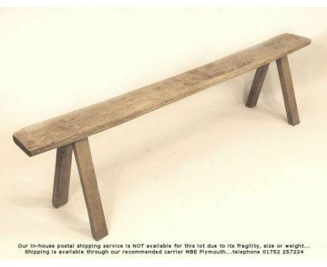 ELM BENCH. A narrow elm bench. Length 167cm. Height 45cm.