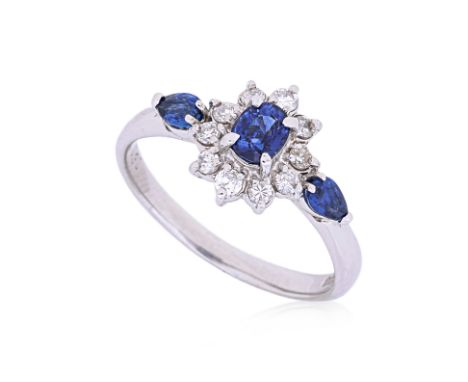 A SAPPHIRE AND DIAMOND RING
Featuring three blue sapphires weighing approximately 0.64 Cts (marked), mounted in a platinum se